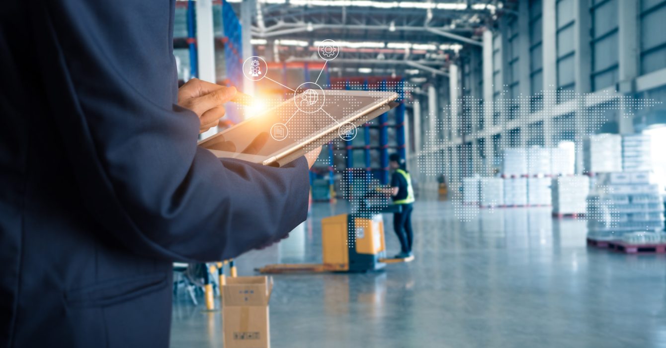 Businessman manager using tablet check and control for workers with Modern Trade warehouse global business commerce concept or import-export commercial logistic. Industry 4.0 concept