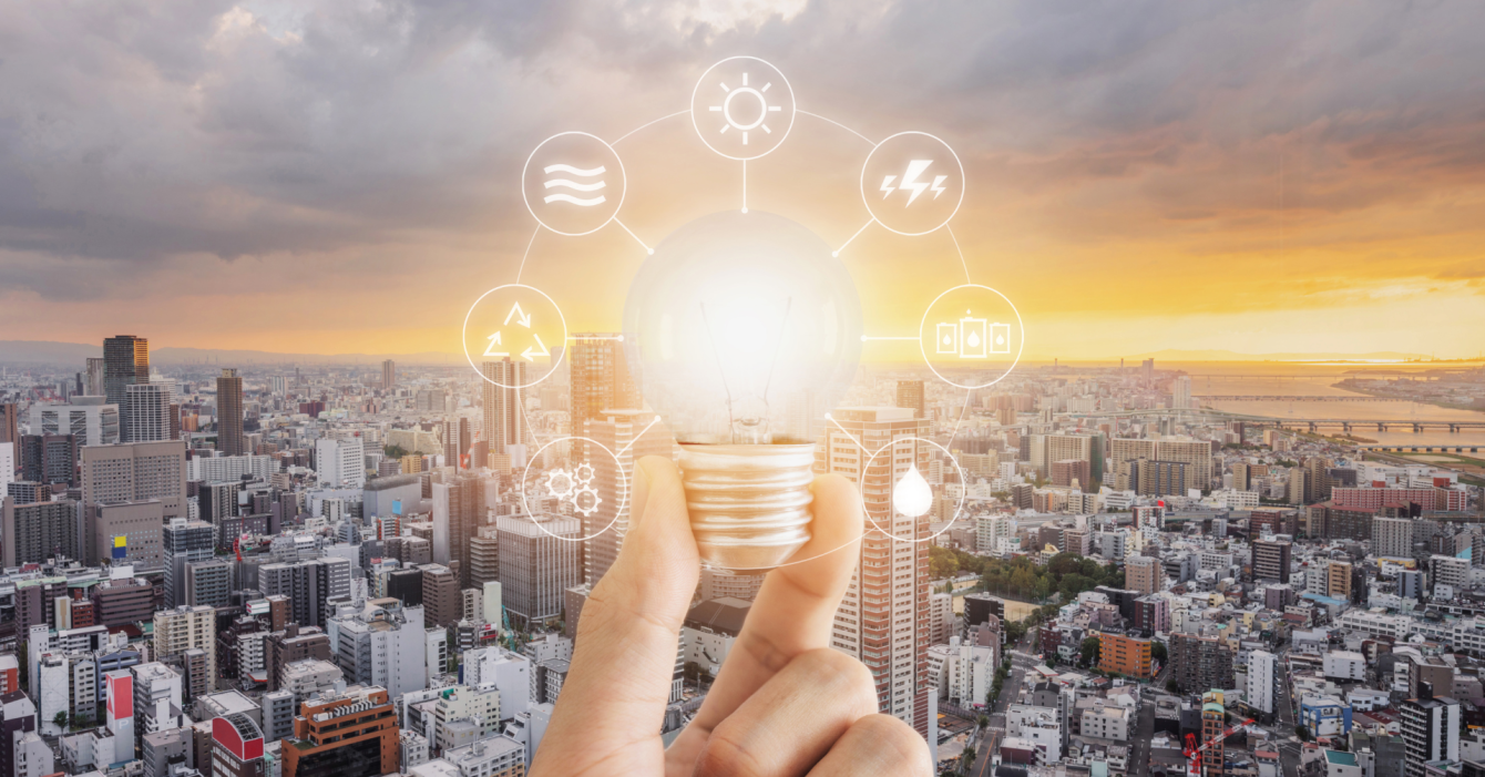 An image of a lightbulb surrounding buildings